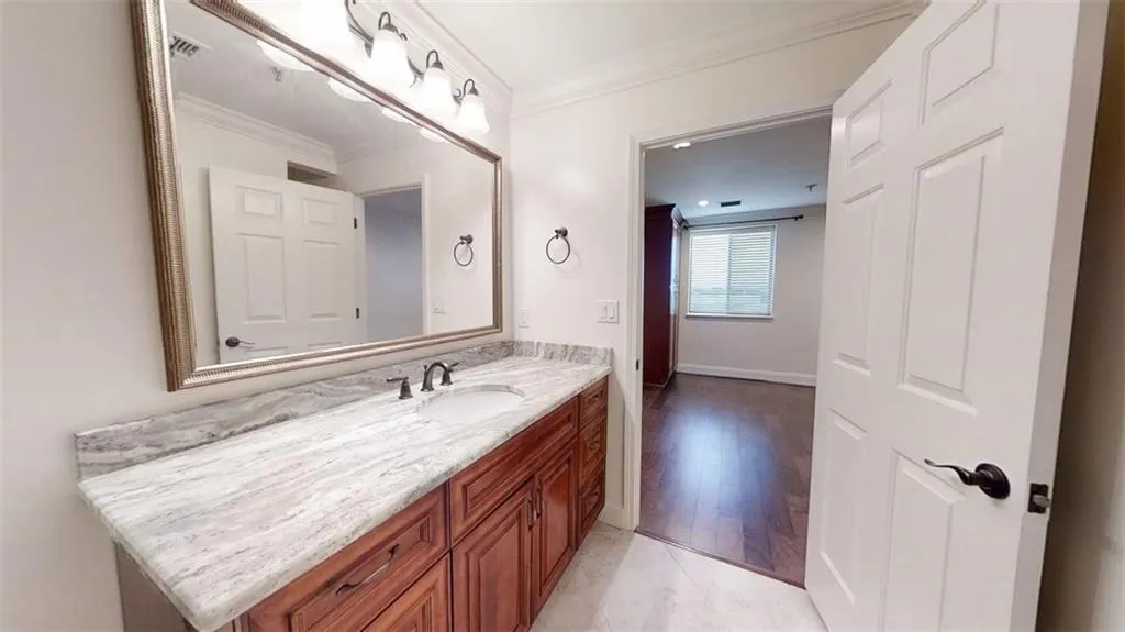 Bathroom featuring vanity and ornamental molding