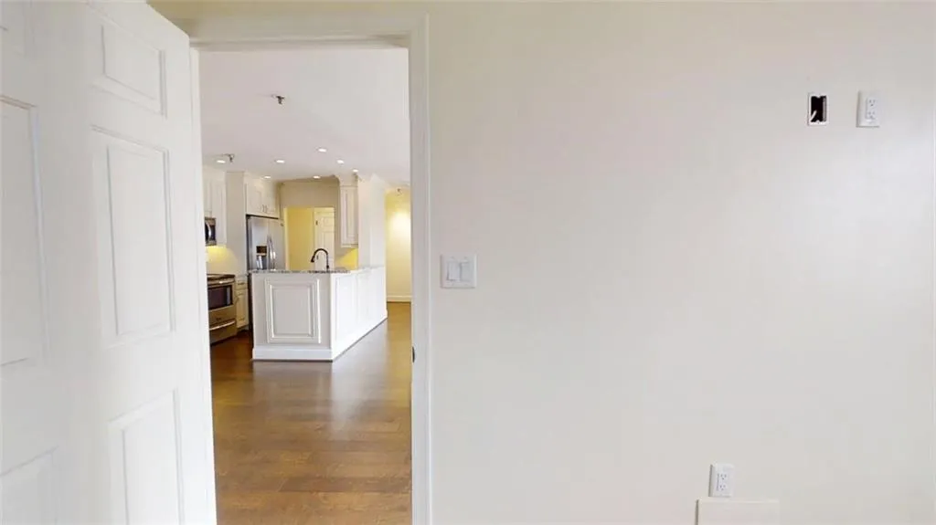 Hallway featuring dark wood-style flooring