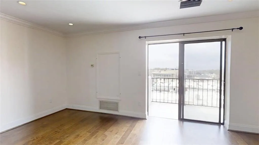 Empty room with dark wood-type flooring, ornamental molding, and recessed lighting