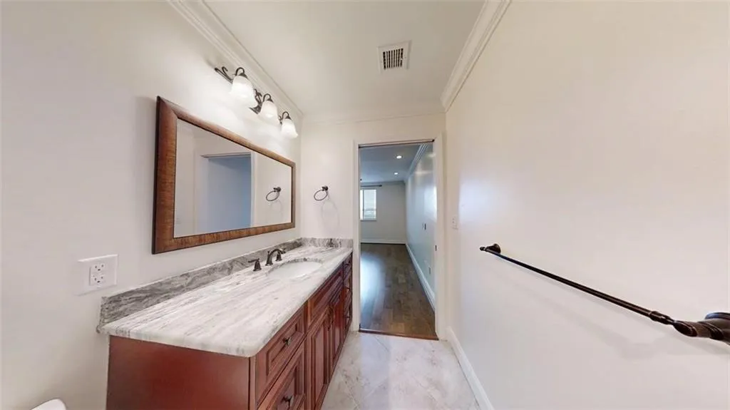 Bathroom with vanity and ornamental molding