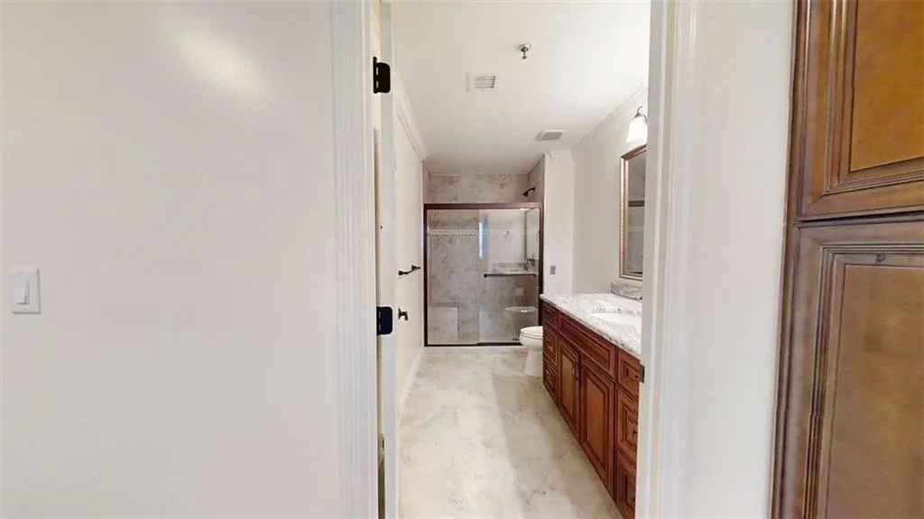 Full bath with vanity and a shower stall