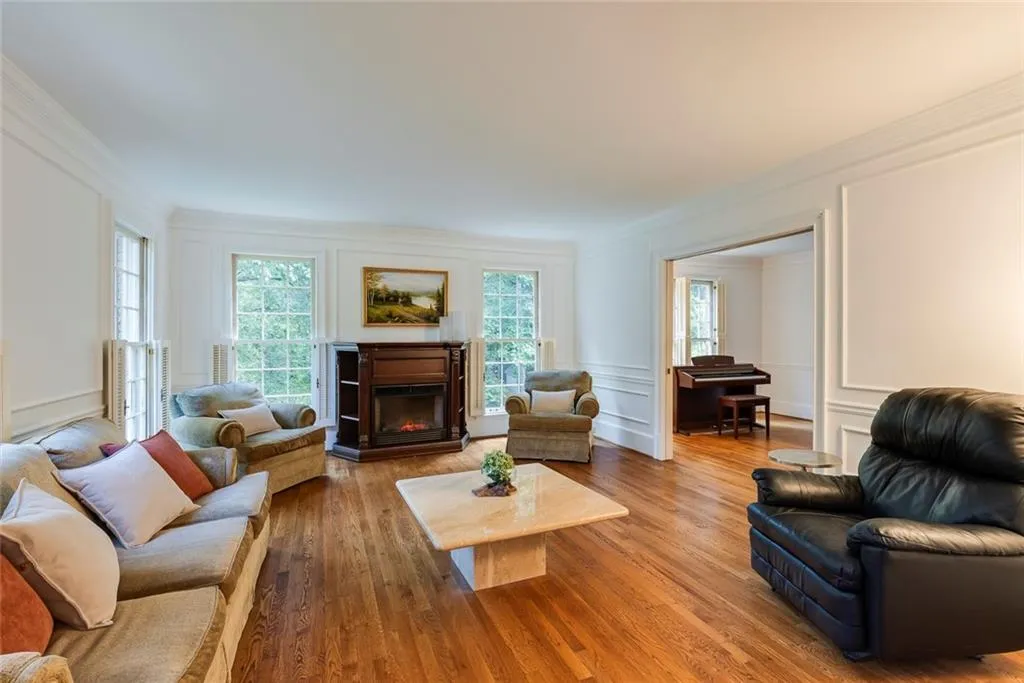 Spacious living room opens to an additional room that can be used as a library, music/playroom or office.