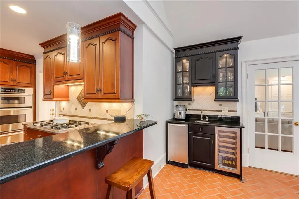 Bar area has a built-in ice maker, sink and beverage cooler.