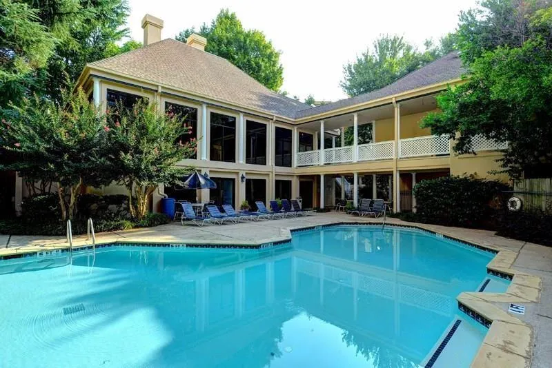 Community pool featuring a patio area and a balcony