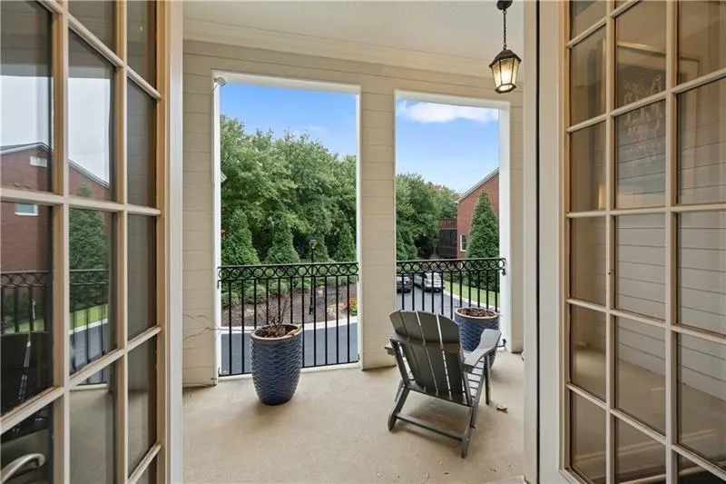 From the living room, open the doors out onto the private front balcony. Plenty of room to enjoy this space and would accommodate for a small table if so desired! Lovely spot to relax and enjoy the luscious greenery!