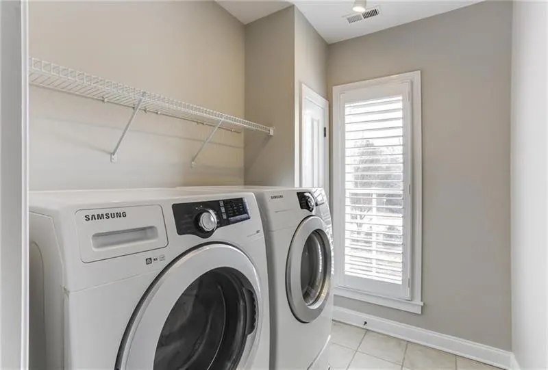 Spacious Laundry Room with with plenty of space to organize and easily accessible from the primary suite!