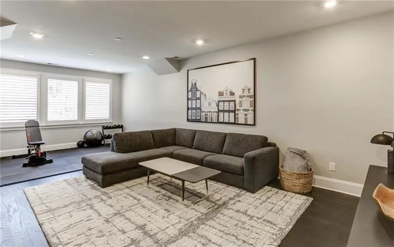 This lovely terrace level space can be used as you like! Here it is featured as a living room and workout area! This is true flex space that can serve as a recreational room or can function as a living room for the downstairs bedroom. Make this your home office if desired!