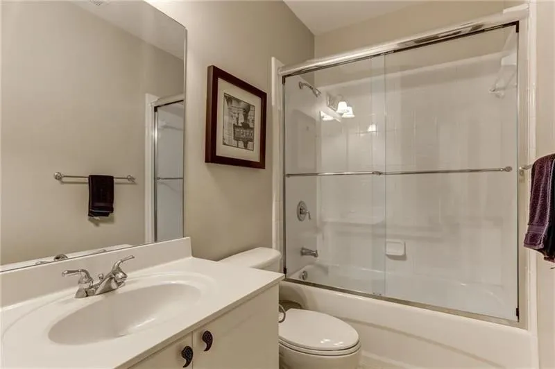 Secondary bathroom located on the terrace level. Custom upgraded shower doors and lovely deep tubs for a relaxing soak!