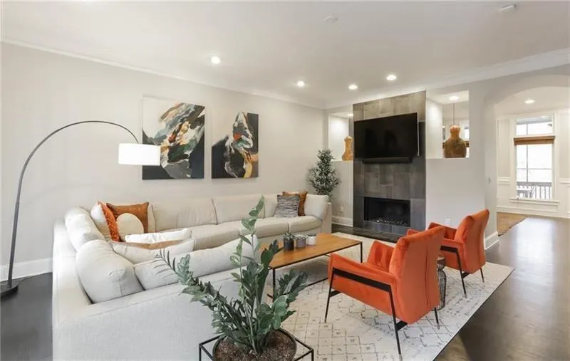 Another view of fireside living room with beautiful stone fireplace detail just off the kitchen and dining room. This tremendous space is both luxurious and comfortable! Amazing function and flow throughout makes this ideal entertaining real estate!