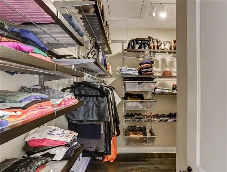 Custom primary closet with ELF closet fixtures can be adjusted to meet your person needs. Huge space that wraps around this wall makes it easy to divide the space if shared!