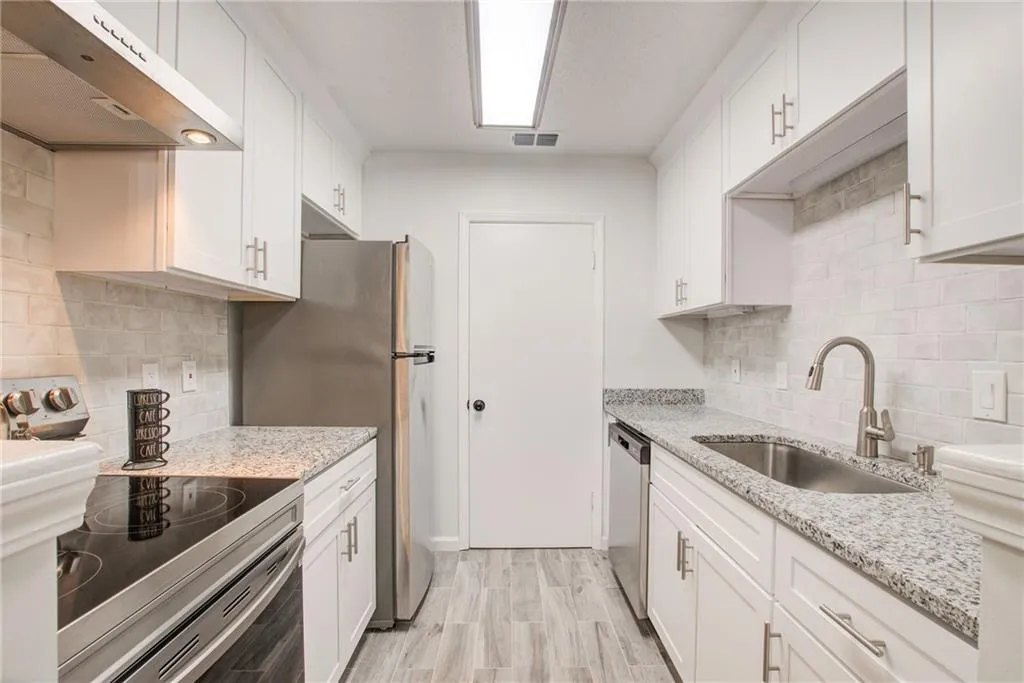 Who is the chef? This gorgeous new kitchen has  all the way to the ceiling new cabinetry, granite  counter tops and stainless  appliances. Just say wow!