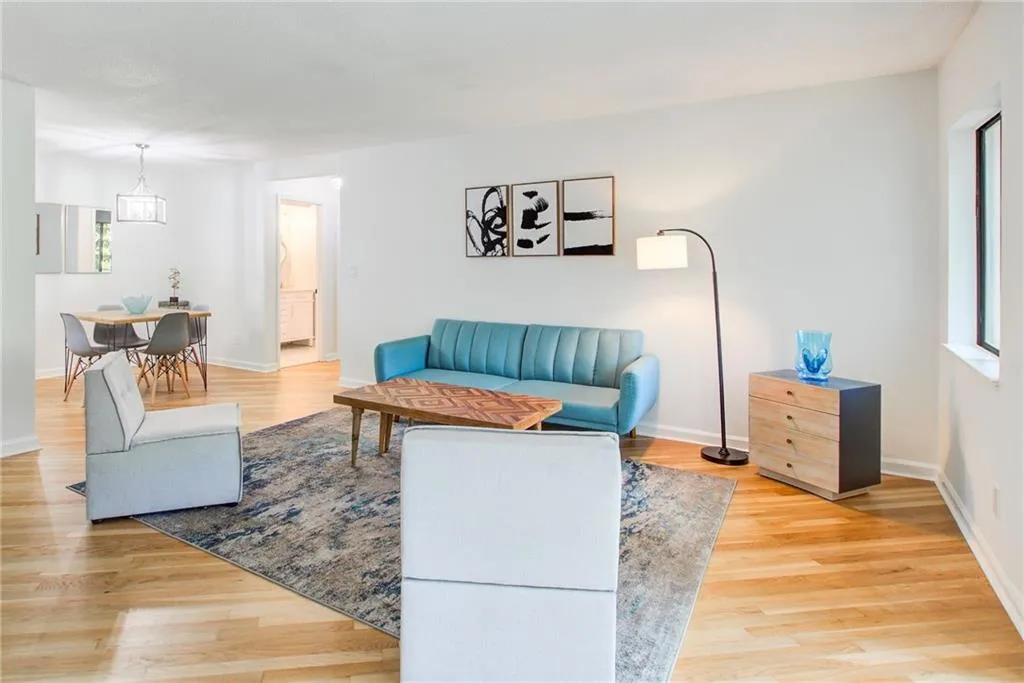 Beautiful living room and  dining room that's full of light. New flooring and fresh paint finish this space.