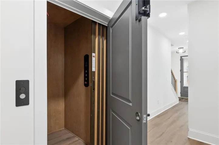 Private residential elevator with wood-finish interior paneling