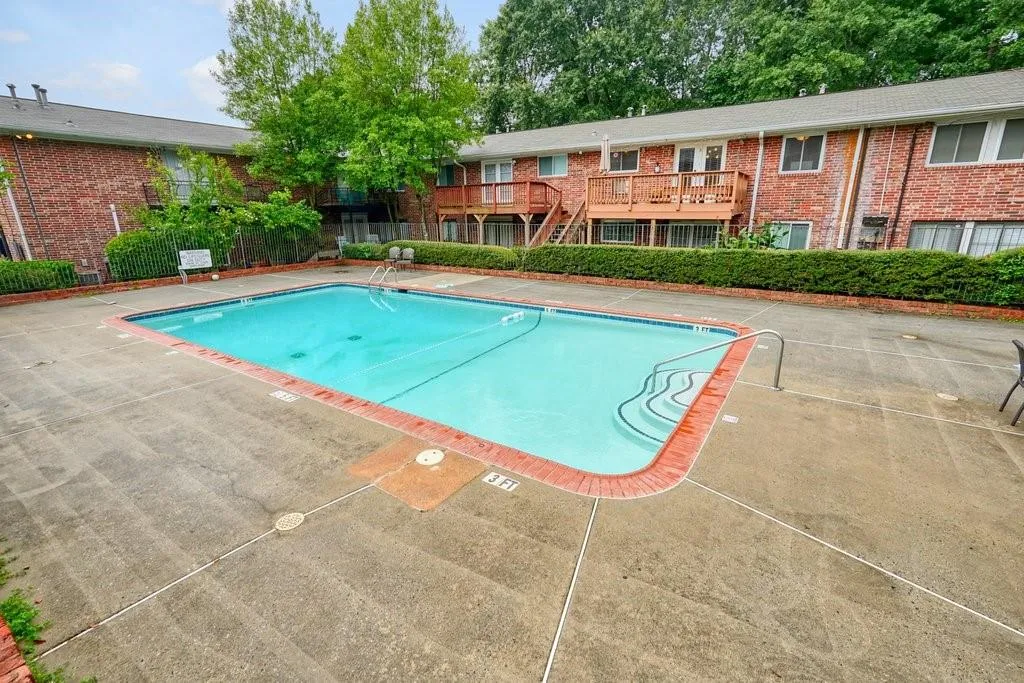 Community pool with a patio