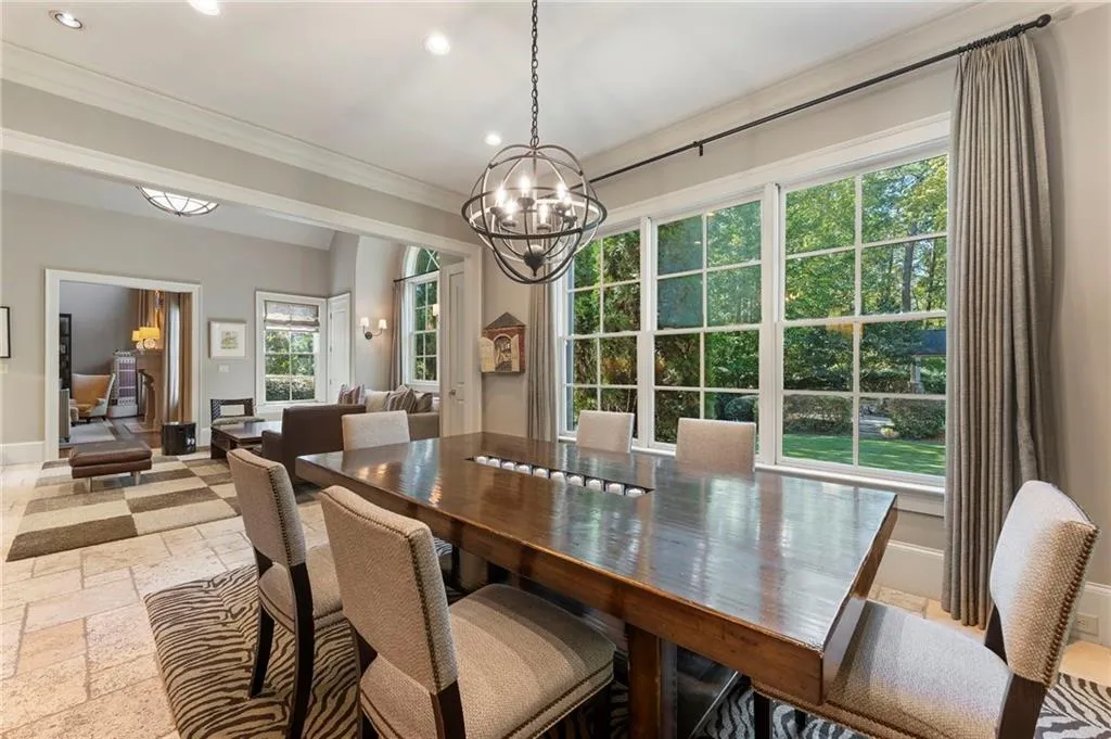Just adjacent to the keeping room, the bright and cheery breakfast room has lots of natural light and beautiful views of the private back yard.
