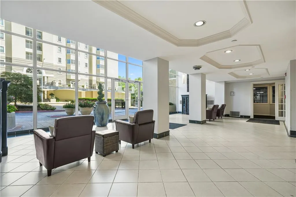 Lobby featuring crown molding, floor to ceiling windows, and recessed lighting