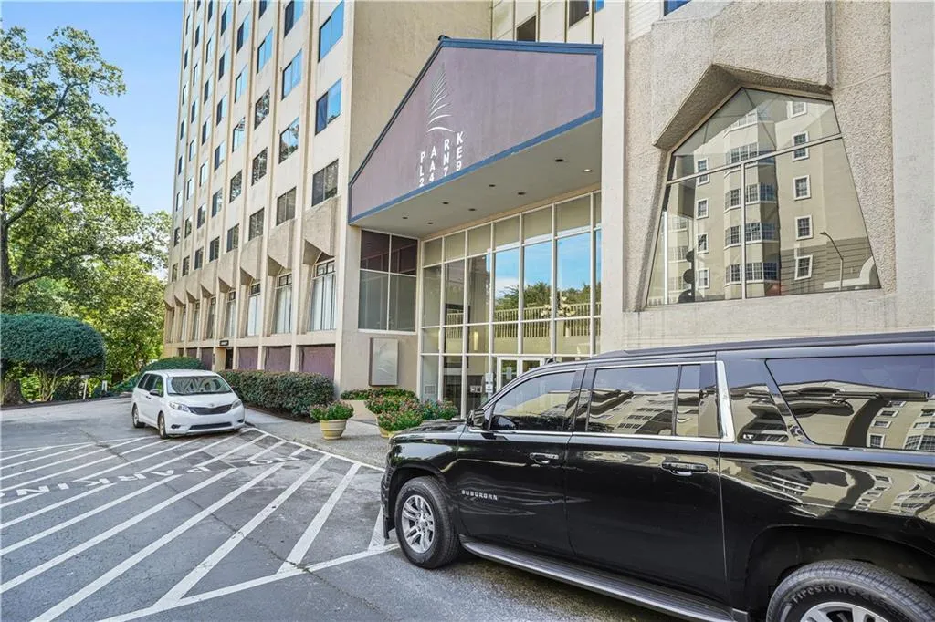 View of building exterior with uncovered parking