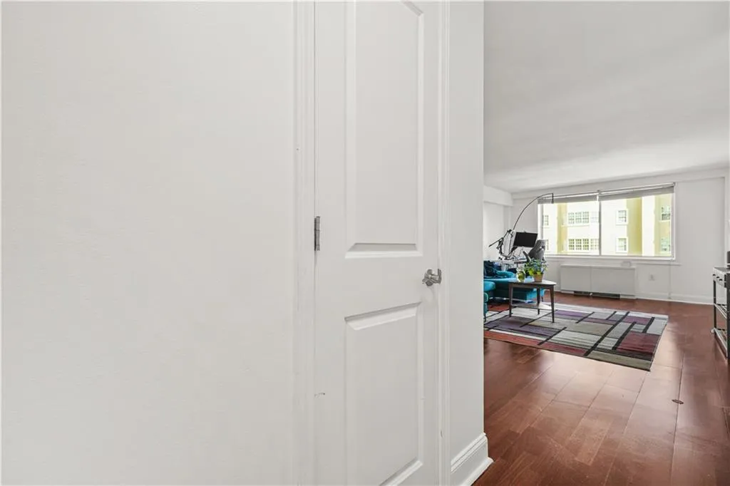 Hall featuring dark wood-style flooring