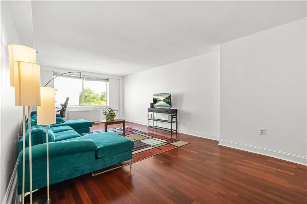 Living area with dark wood finished floors and baseboards