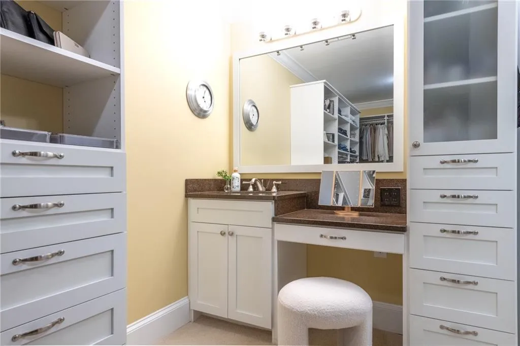 Vanity, sink, towers in primary closet