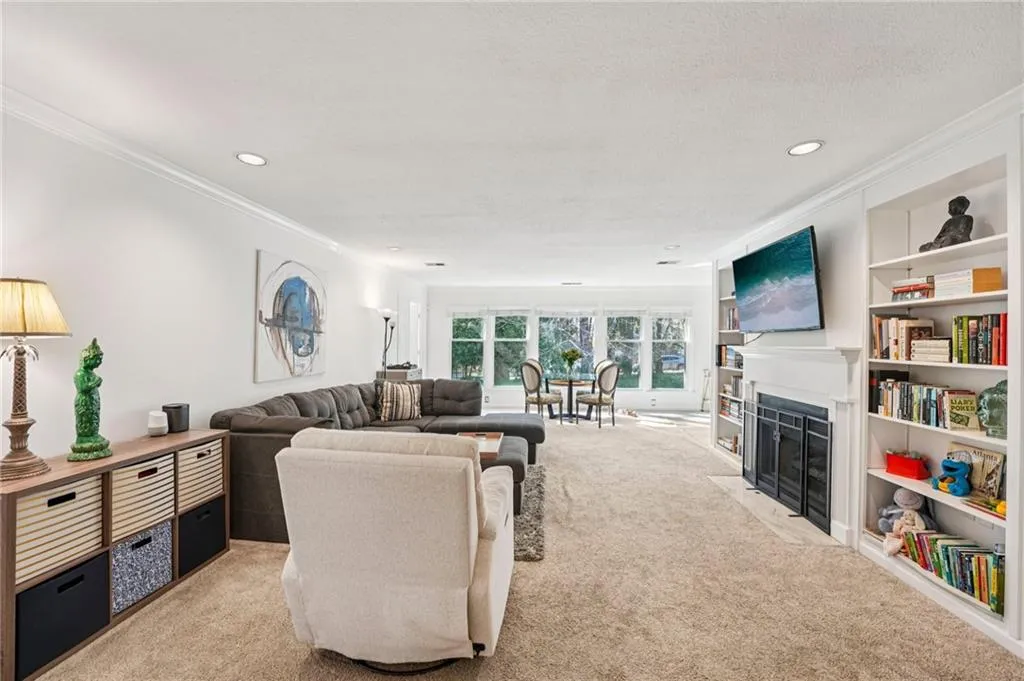 featuring beautiful bookcases and a wall of windows!