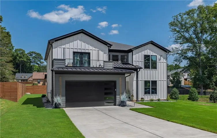 Modern farmhouse exterior with vertical white siding and dark trim