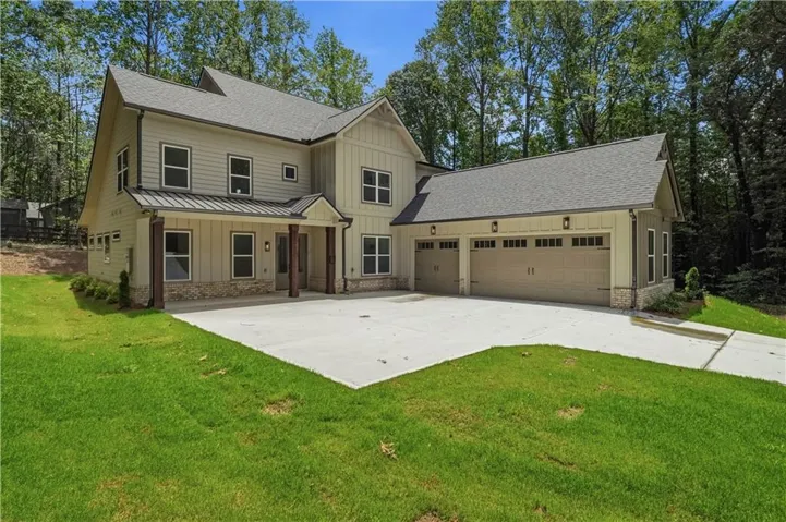 Contemporary multi-story exterior with light beige siding and dark trim windows