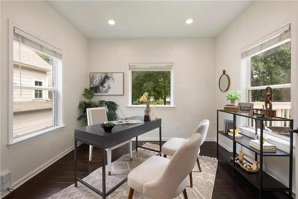 Office space with dark wood-style flooring, healthy amount of natural light, and recessed lighting