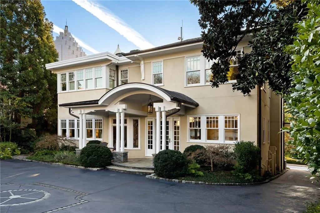 View of front facade featuring stucco siding and a patio area