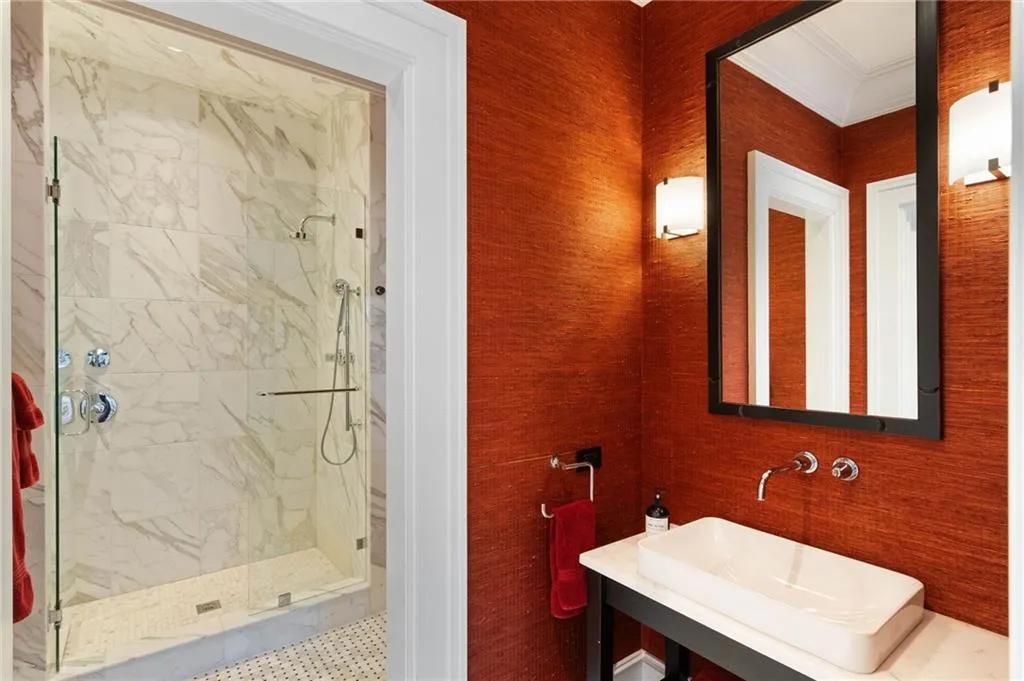 Full bathroom with a marble finish shower and ornamental molding