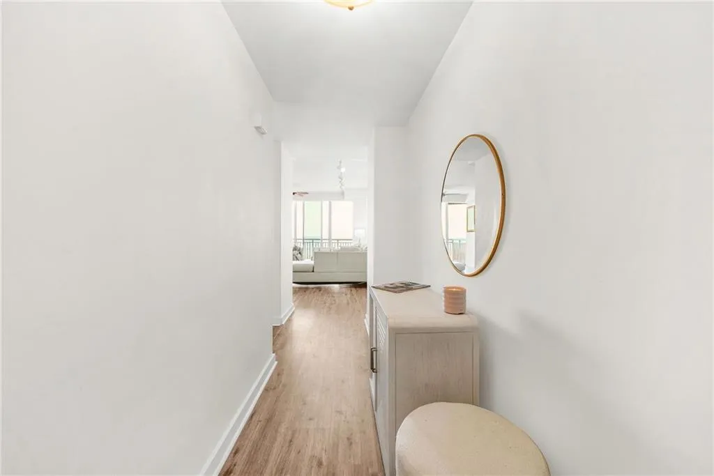 Hall with light wood-type flooring and baseboards