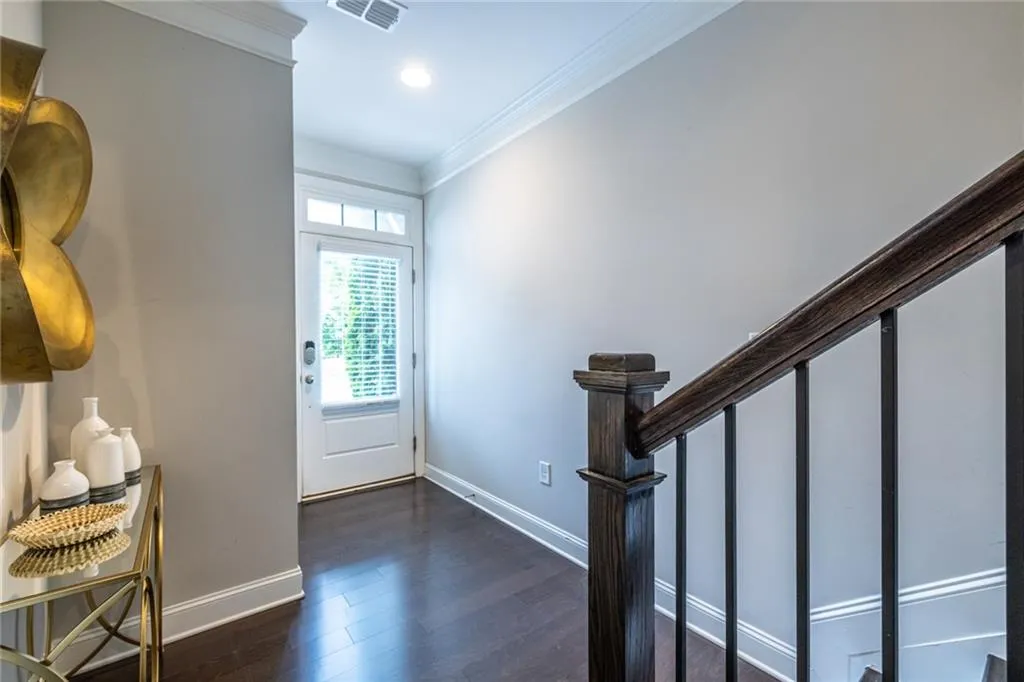 Bright and welcoming entryway with rich hardwood floors and stylish trim details, setting the tone for the rest of the home.