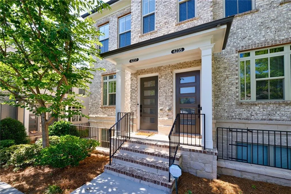 Nestled in the highly sought-after gated community of Townes at Chastain