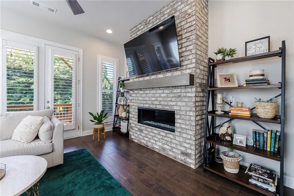 The great room features a modern fireplace and opens to one of two decks in the home.