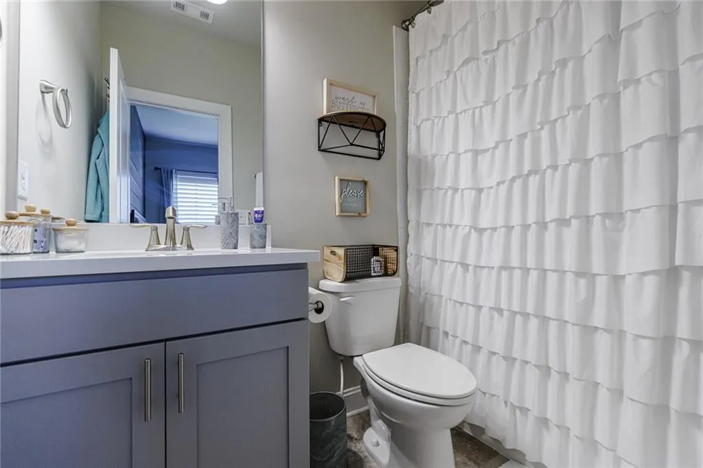 The secondary bedroom features an updated bathroom with a shower/tub combo