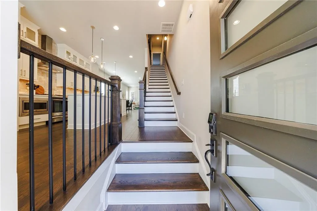 As you step inside, you’ll be greeted by abundant natural light flooding the open floorplan, highlighted by gorgeous hardwood floors throughout.