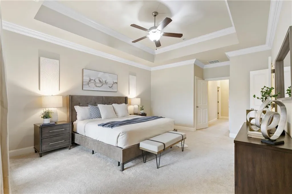 Primary bedroom with tray ceilings
