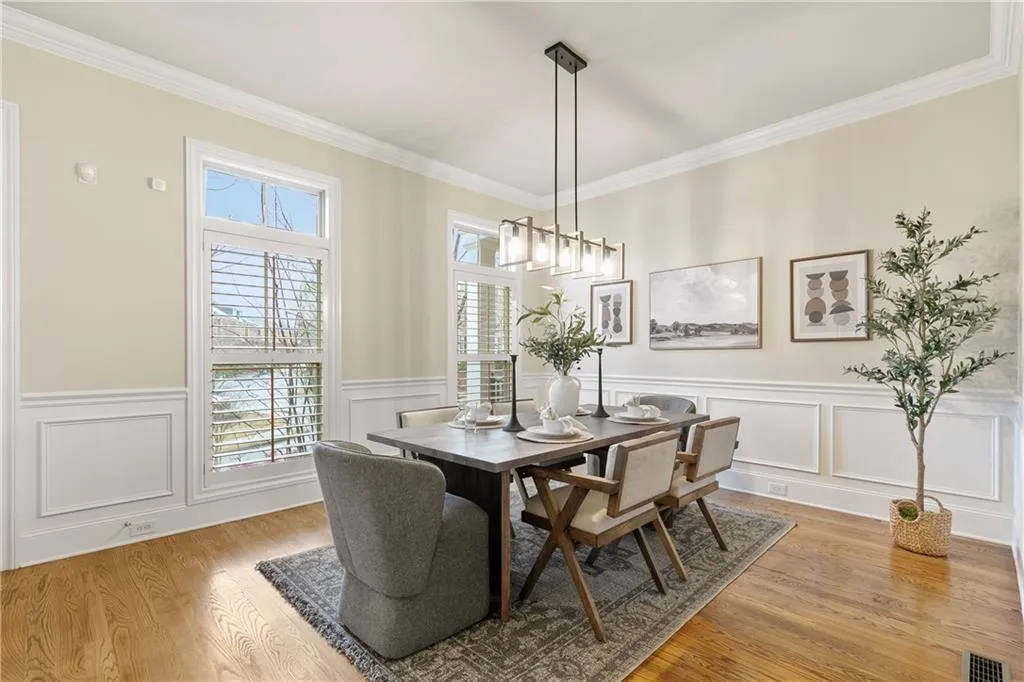 Dining space with light hardwoods and plantation window shutters