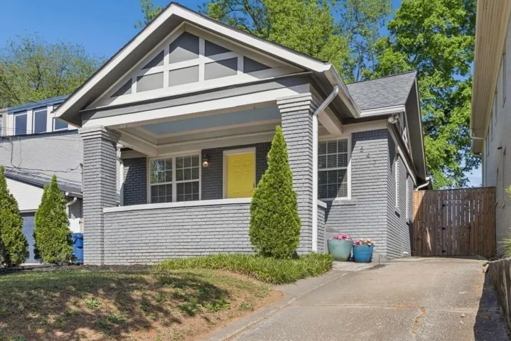 Craftsman-style facade with grey brick and shingle siding