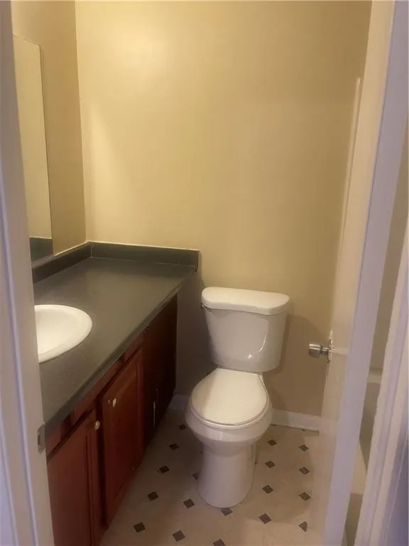Bathroom with vanity, tile patterned flooring, and toilet