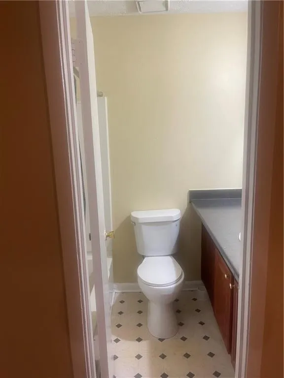 Full bathroom with tile patterned flooring, bathing tub / shower combination, toilet, and vanity