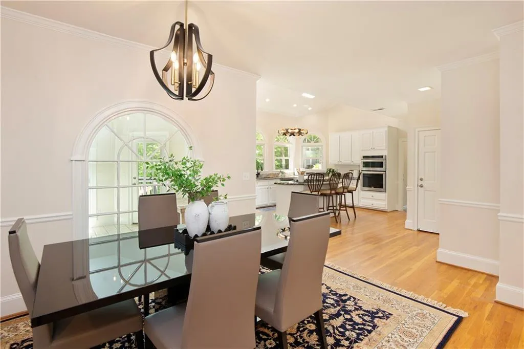The casual dining area opens effortlessly toward the kitchen, blending everyday living with elevated style and convenience.