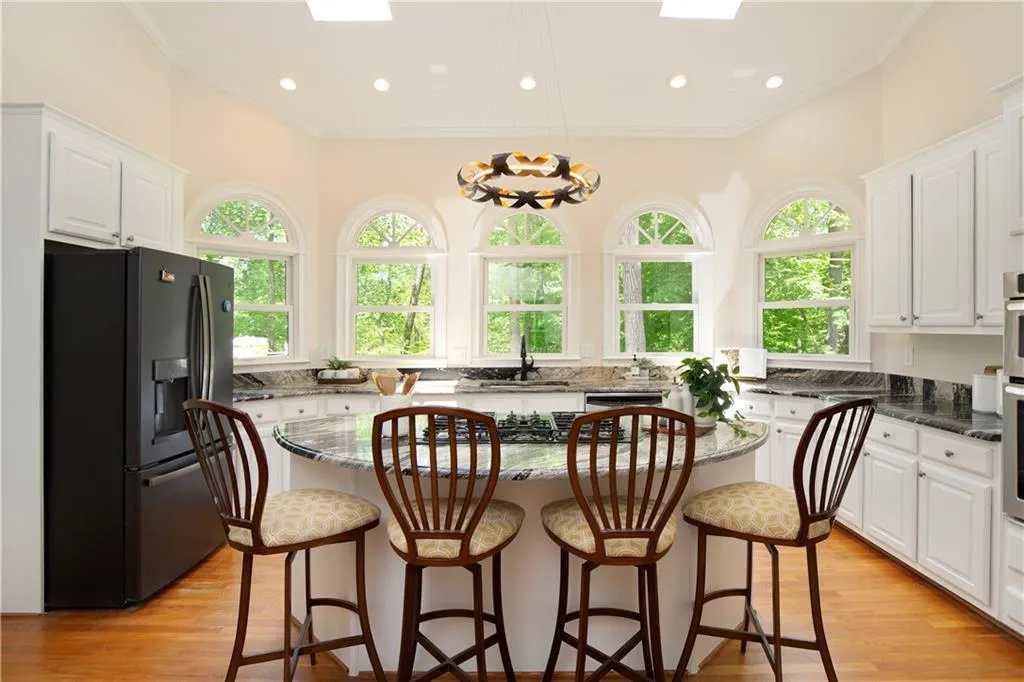 The casual dining area flows to an expansive kitchen designed for both functionality and connection.
