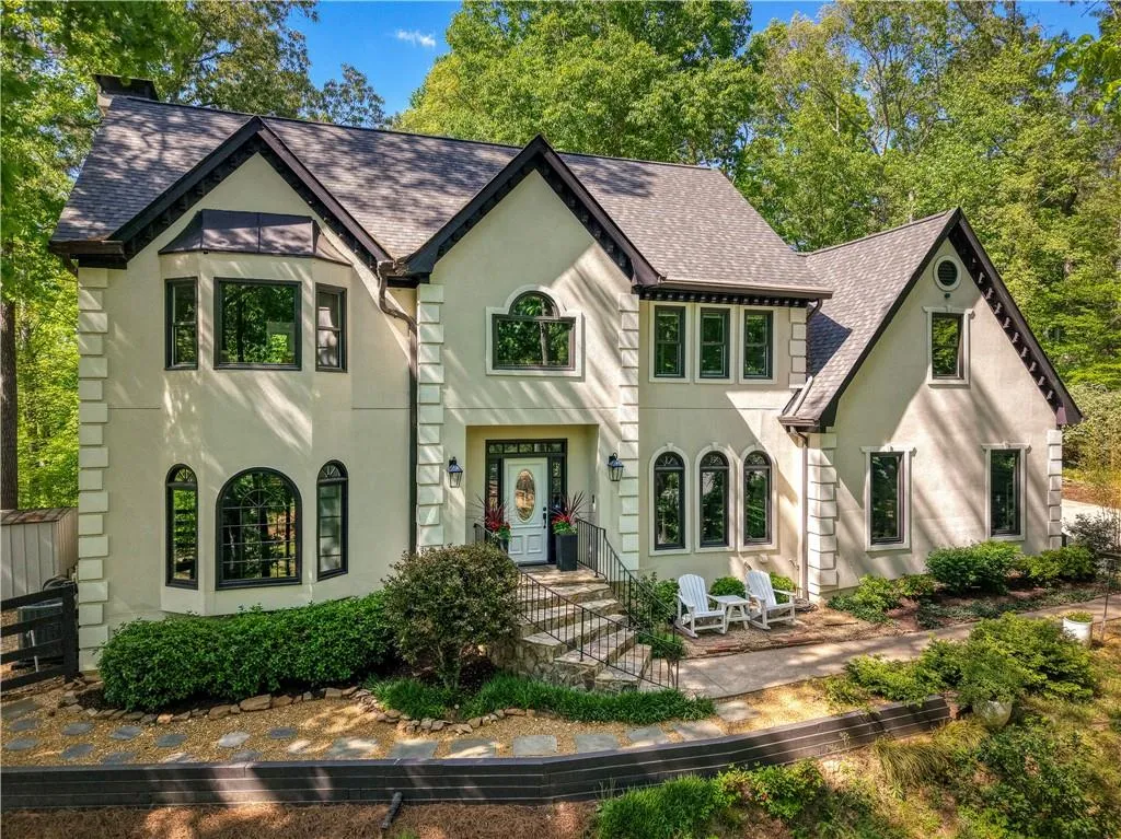 Classic architectural details and lush natural surroundings create a warm, inviting first impression, blending timeless design with tranquil living.