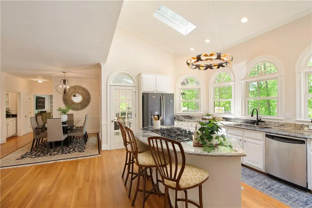 The kitchen flows seamlessly into the casual dining area and living room beyond, offering effortless connectivity ideal for everyday living and entertaining.