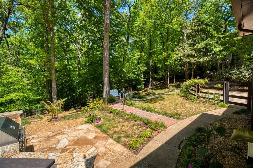 The landscaped grounds offer a blend of open space for gardening and natural beauty, creating a tranquil outdoor setting.