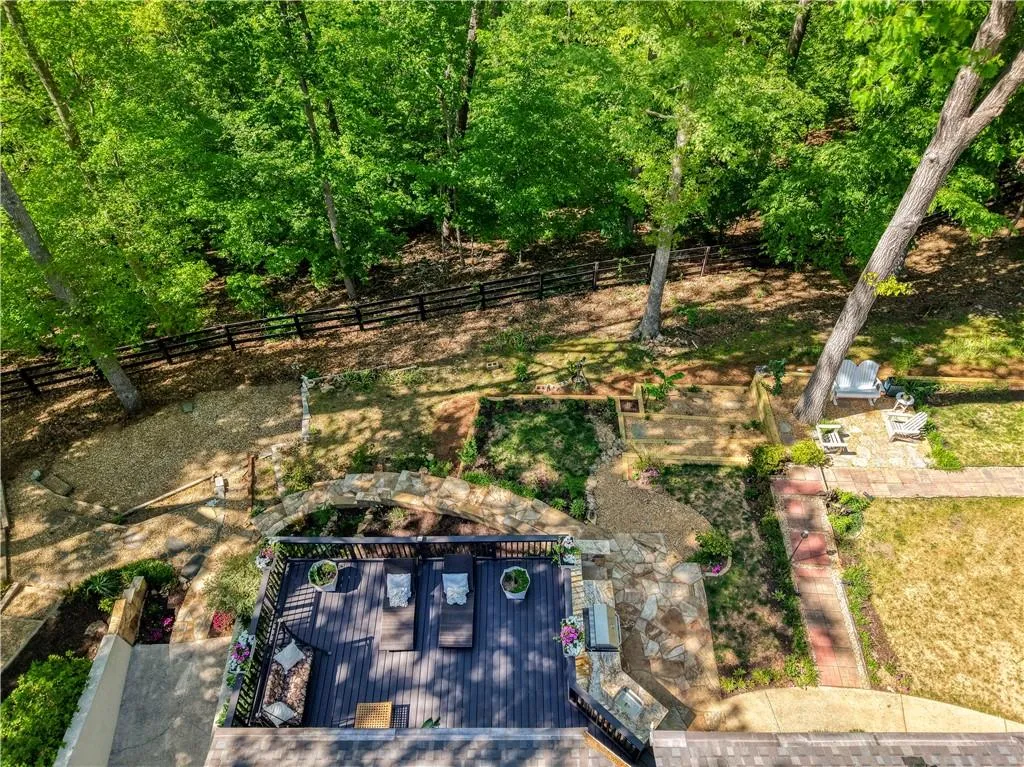 Elevated views highlight the home’s setting on a generous, 1-acre wooded lot with a seamless blend of indoor and outdoor living.
