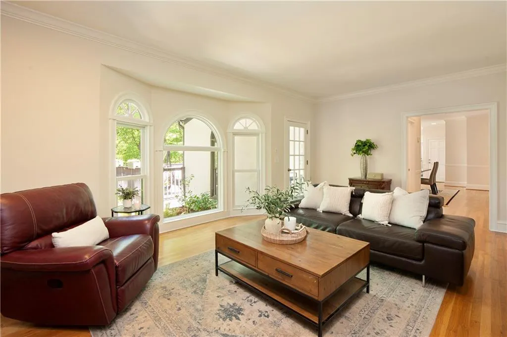 Another view of the family room highlights the seamless flow, abundant natural light, and tranquil views that define the home’s main living spaces.