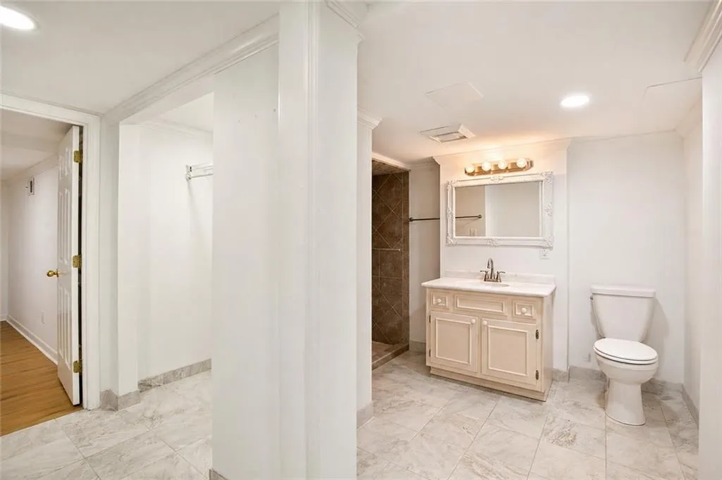 The terrace level bathroom features a functional layout with a walk-in shower, offering comfort and convenience.