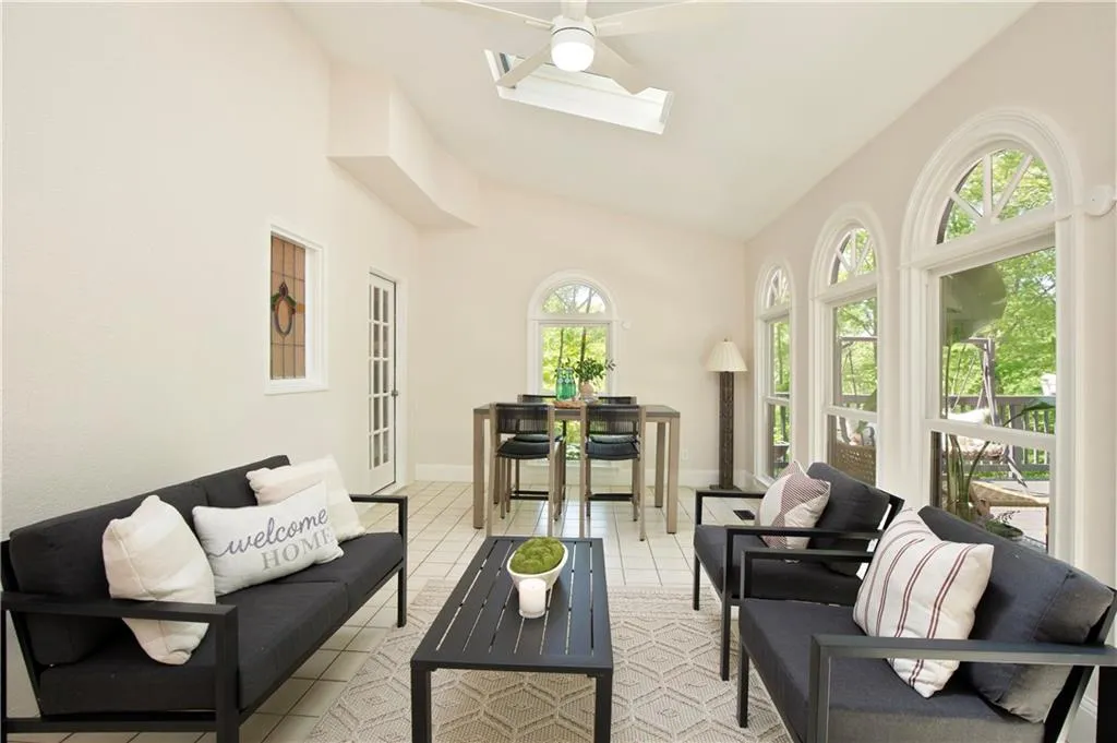 The sunroom provides a peaceful retreat, surrounded by windows and filled with natural light—perfect for relaxing or enjoying morning coffee.